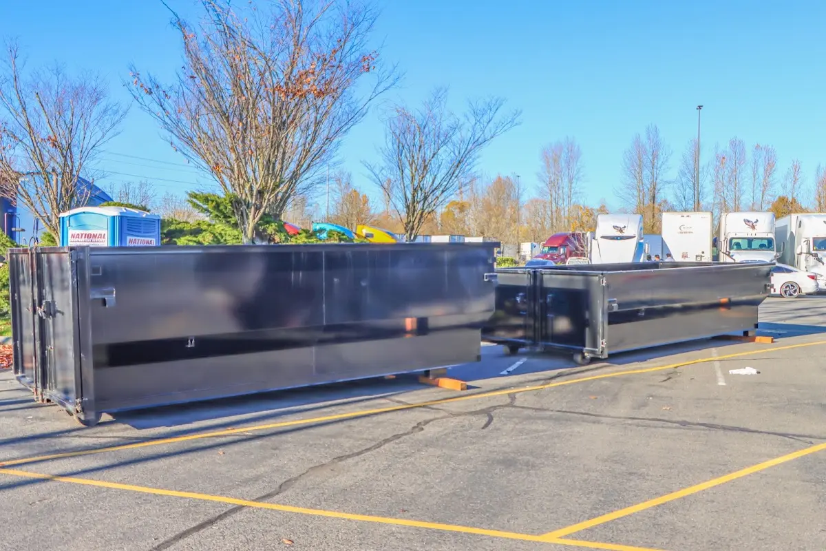 Professional dumpster rental service with roll-off container on residential driveway in Branchburg